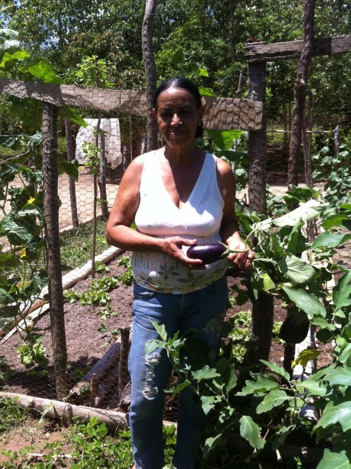 Ramona showing some of the produce in her vegetable garden