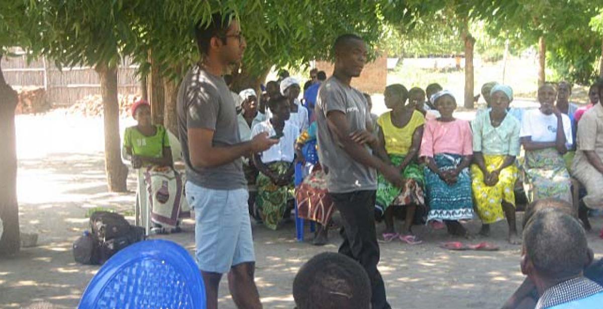 UK volunteer Runil facilitating a waste management workshop with Team Leader James interpreting