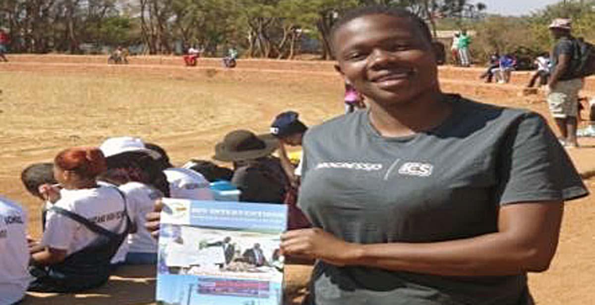 Holding a sample of books we were distributing during the Y.E.S League