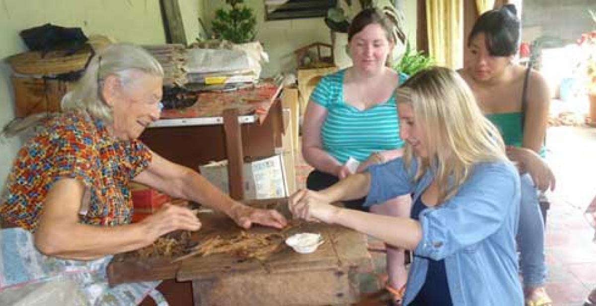 Lily learns to roll a cigar from a 91 year old pro.