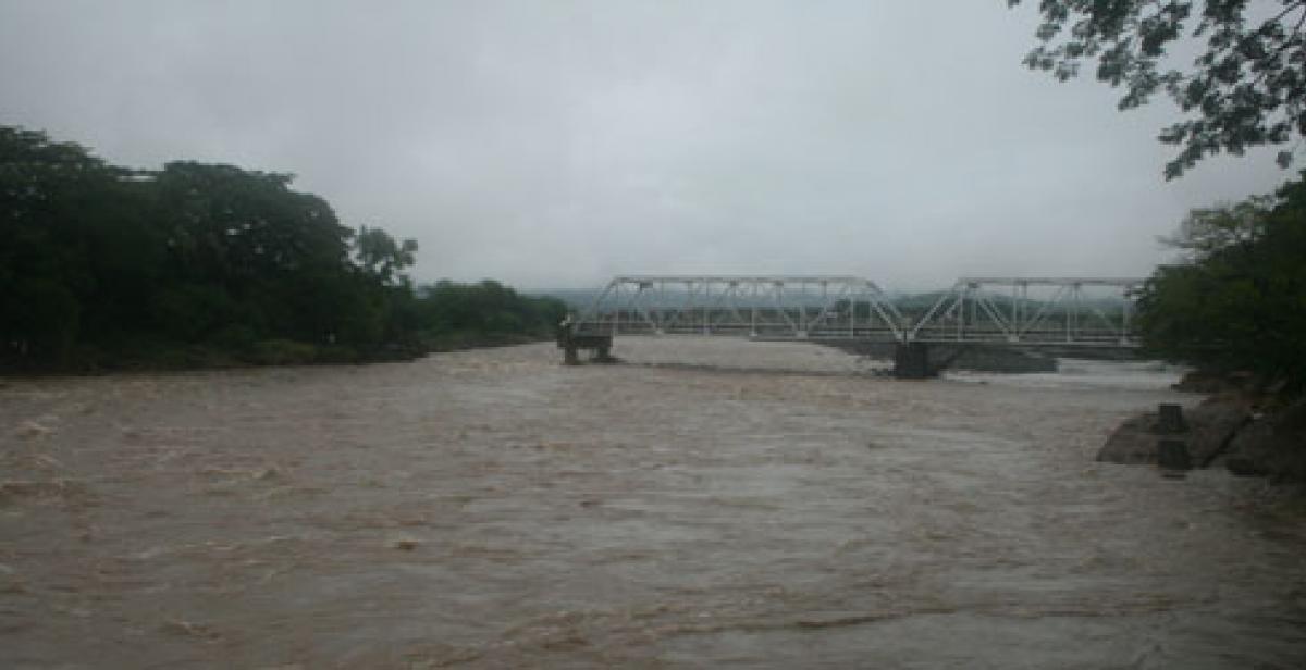 Bridge damaged by floods on El Salvador border