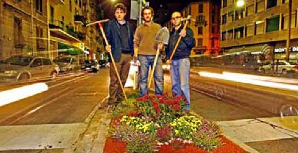 Guerilla gardeners pose by their new gardens in the dead of night