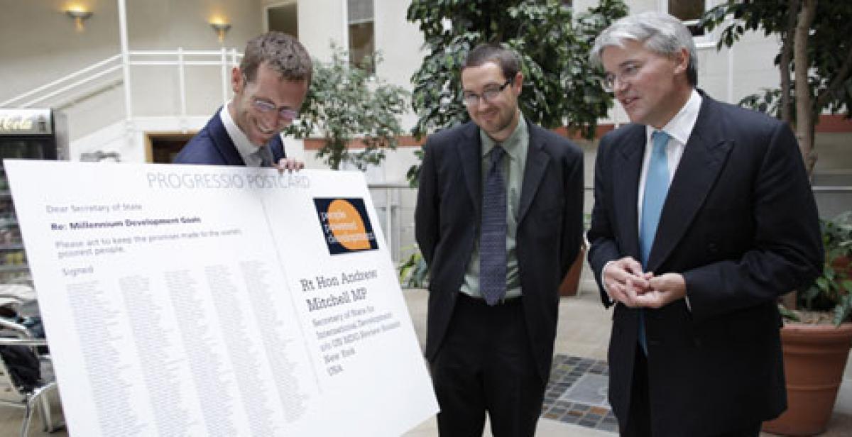 Giant postcard of MDG petition is presented to Andrew Mitchell MP