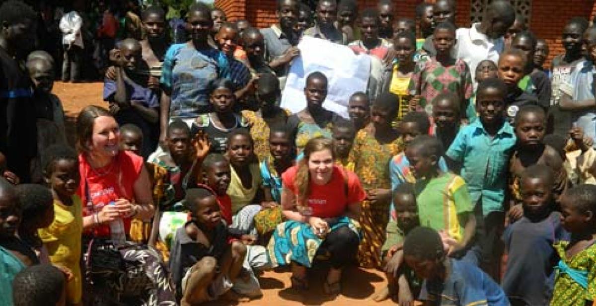 ICS volunteers Jessie O’Keefe and Jenny Vaughan with young people in the village