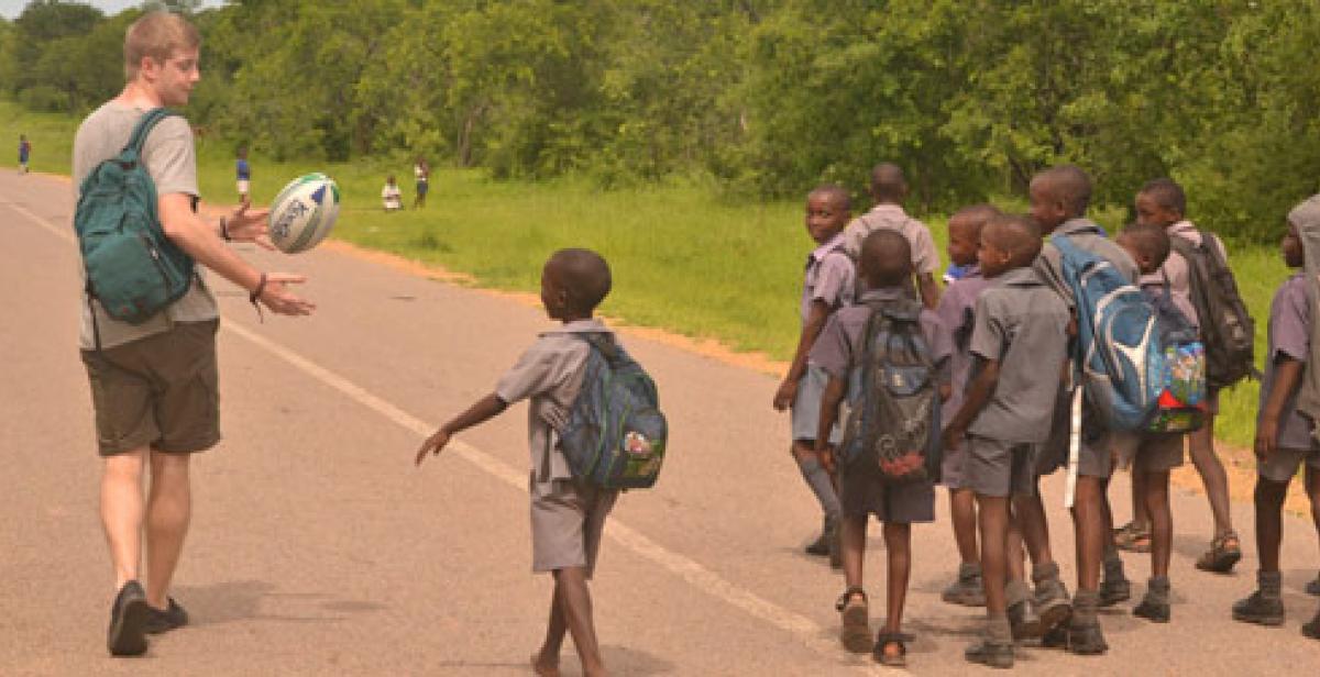 Progressio ICS UK volunteer with school children in Zimbabwe