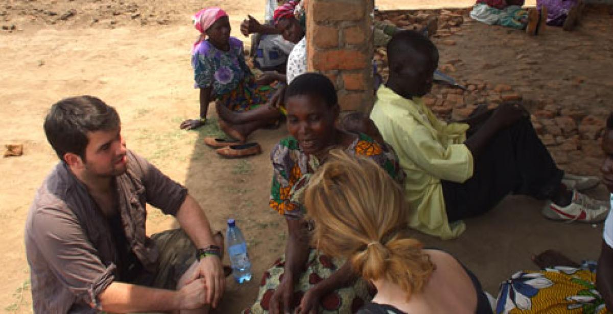 ICS volunteers talking to villagers in Malawi