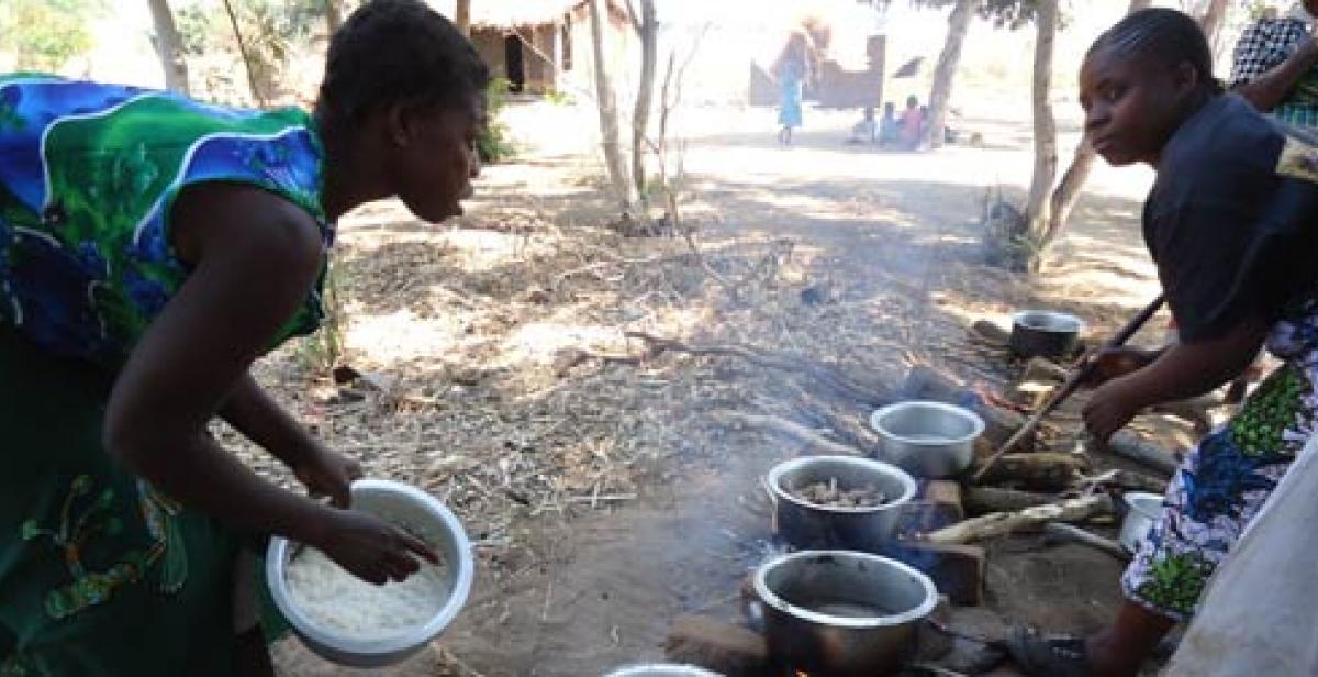 Women cooking in a village in Malawi