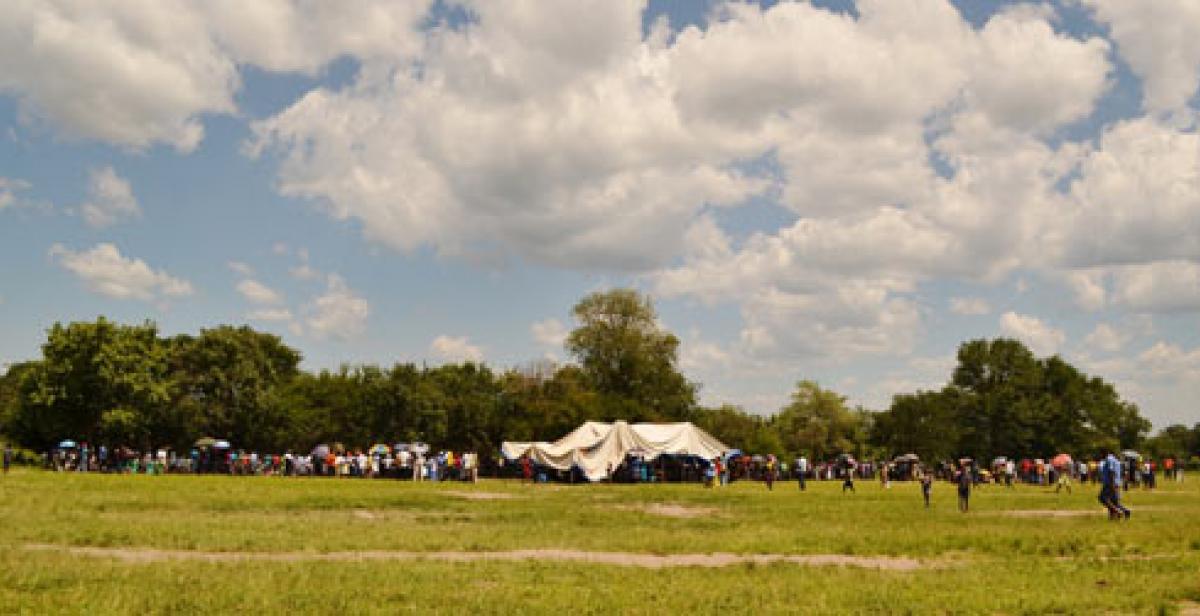  Setting the scene: People begin to arrive at Lubimbi primary school as the stak