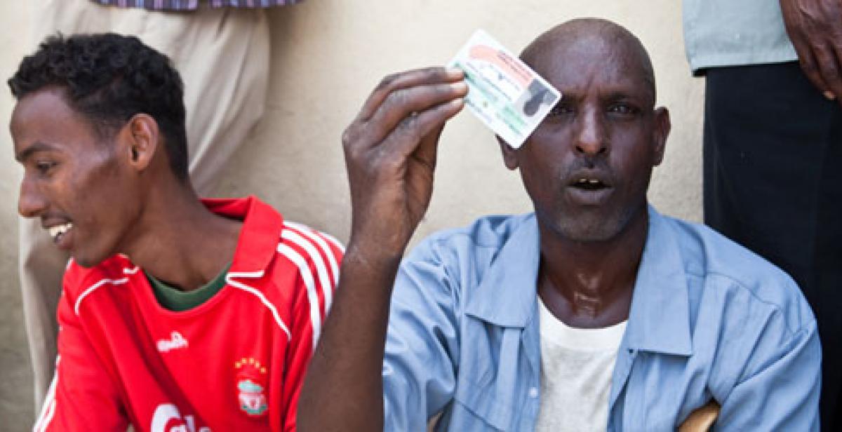 A man holds up his voter ID card in Somaliland