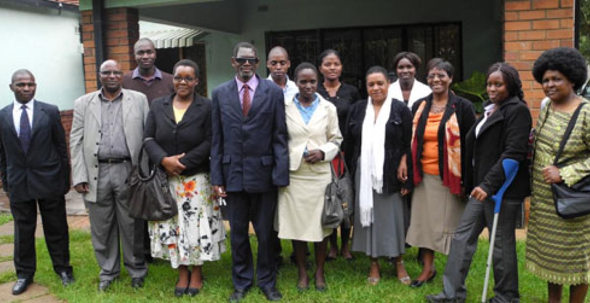 Bothwell is pictured in the centre wearing dark suit and glasses