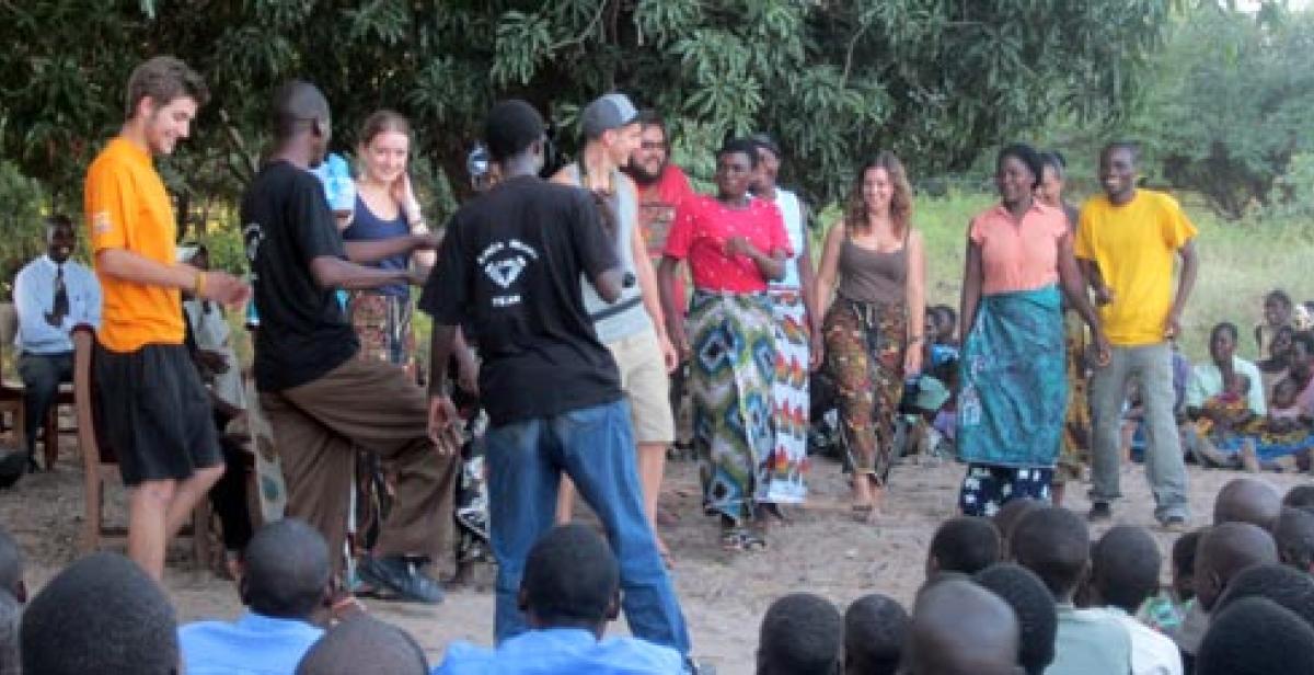 Volunteers and villagers dancing