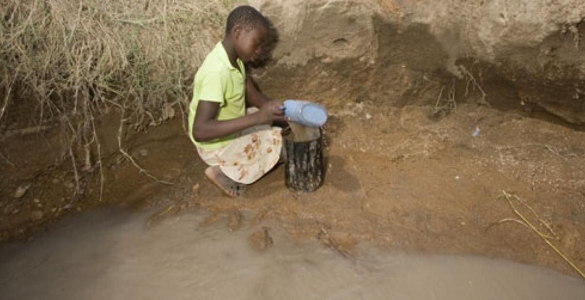 Girl collecting water in Zimbabwe