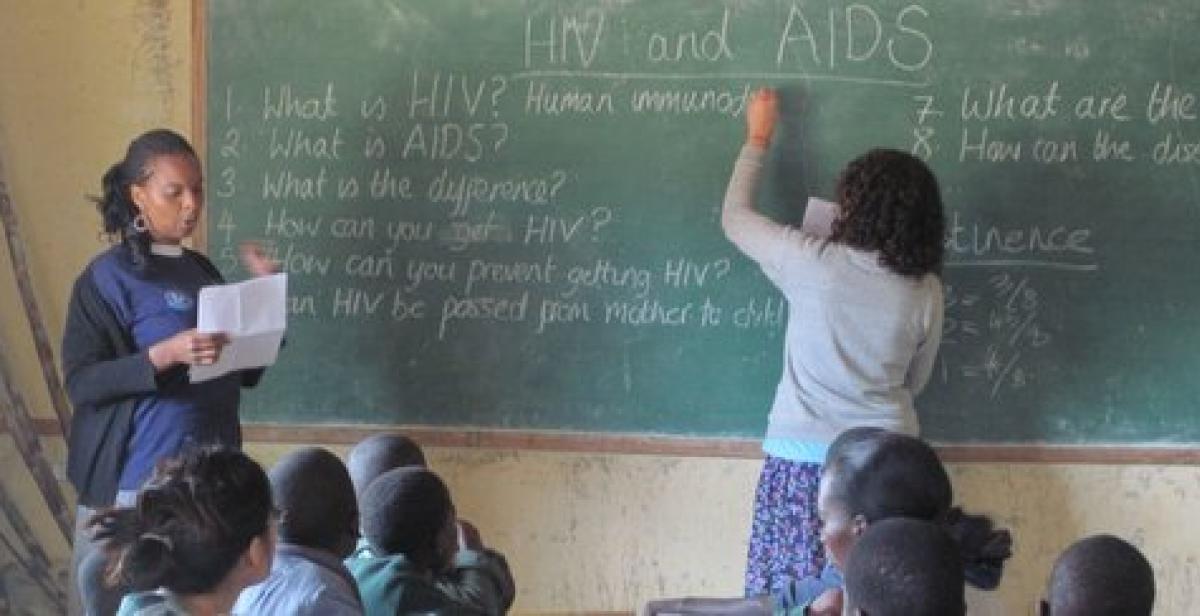 Yvonne and Charlee teaching about HIV in a classroom