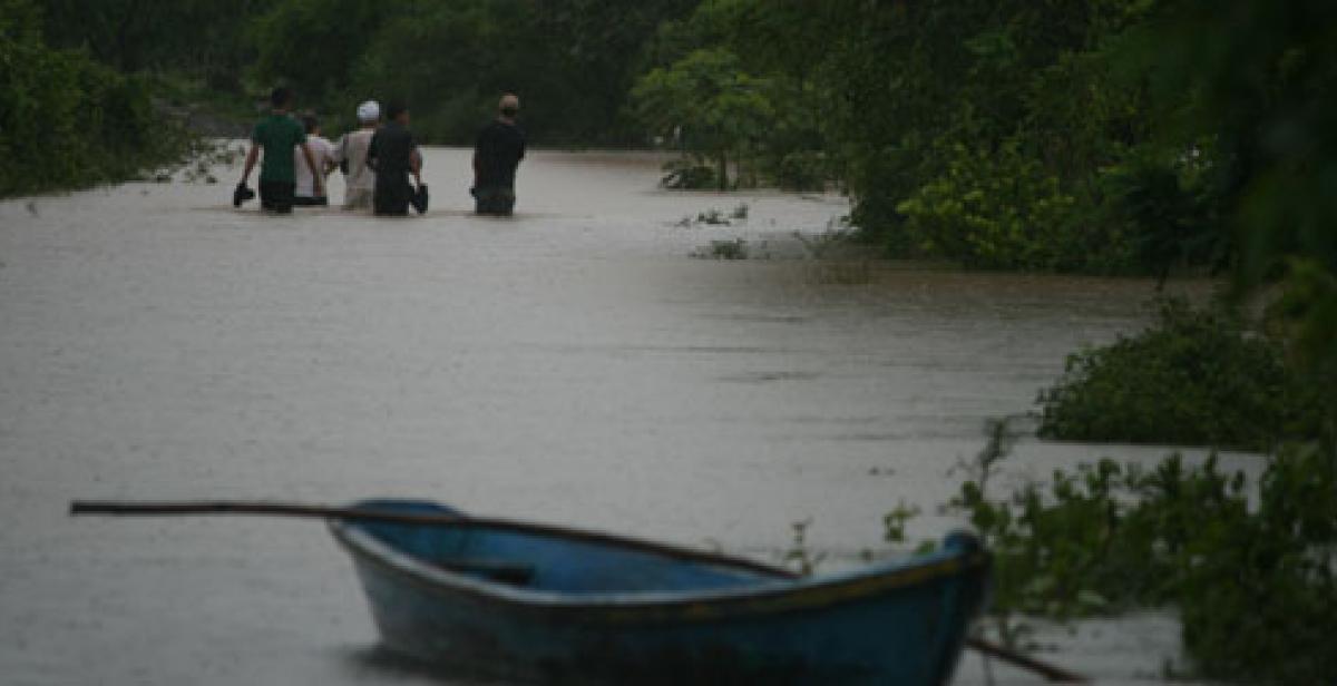 People walking through flood in El Salvador