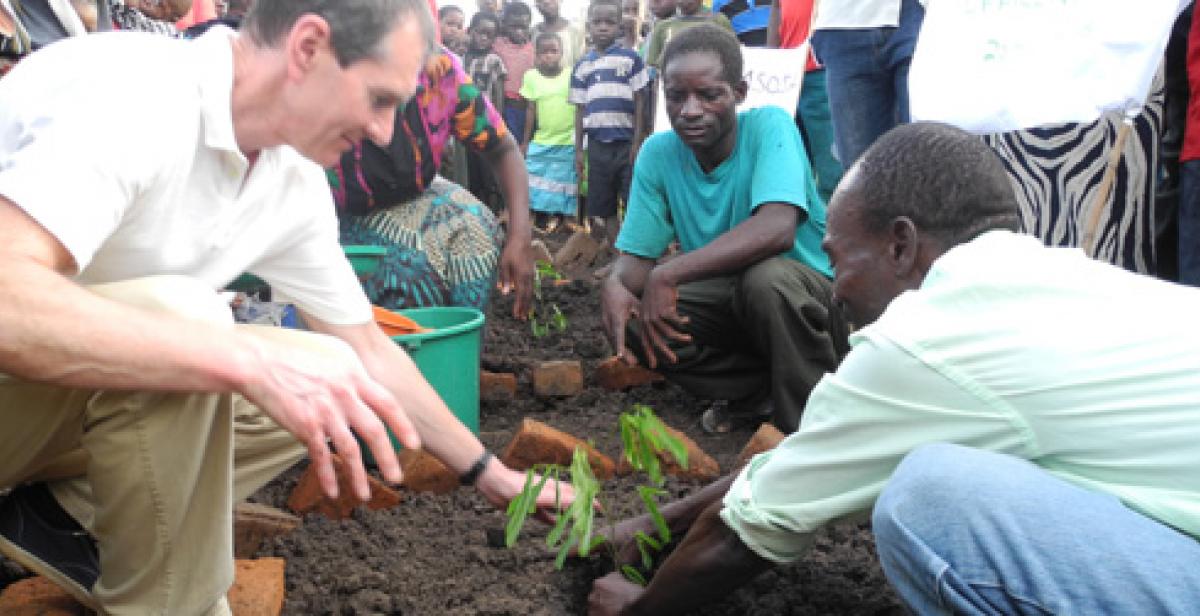 Mark plants a tree at Chembe village Forest Club, Malawi