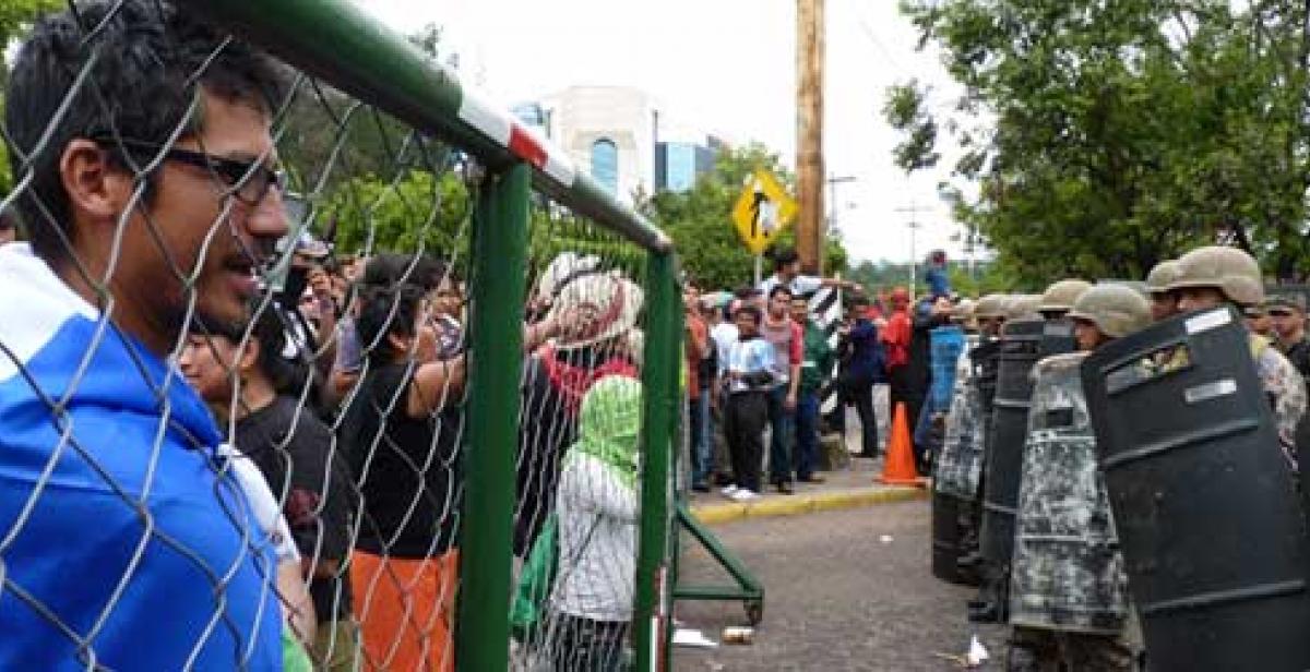 Protesters face riot control officers