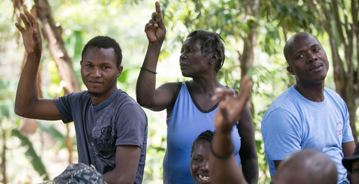 People taking part in a community meeting in Haiti