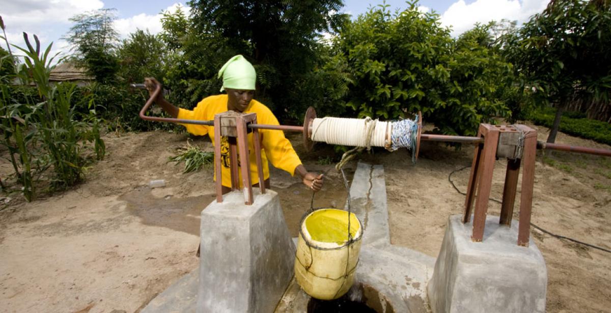 Litah Sibanda, a farmer in Lupane, Zimbabwe, drawing water from a well
