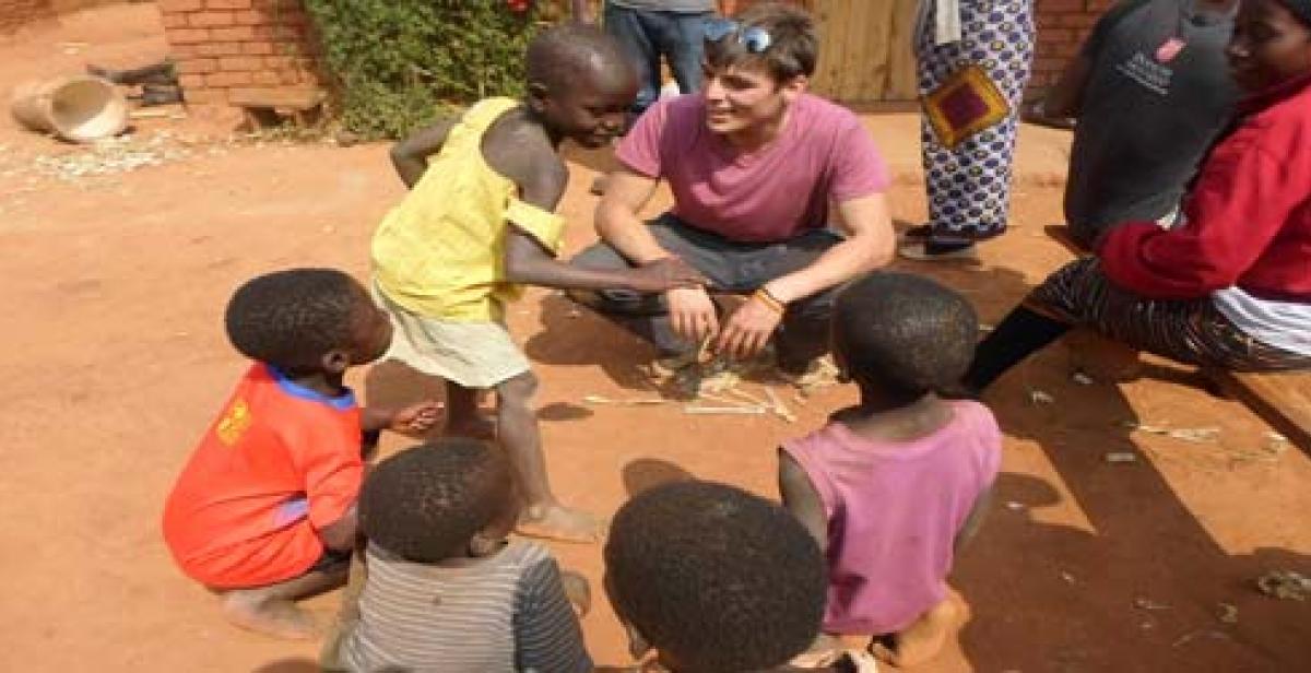 One of the UK ICS volunteers interacting with local children 