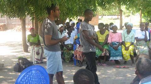 UK volunteer Runil facilitating a waste management workshop with Team Leader James interpreting