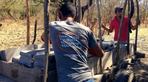 Volunteers helping the beneficiaries pick up their materials