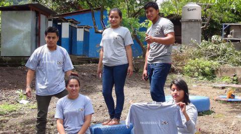 Michael (holding the t-shirt) with fellow ICS national alumni volunteering in the construction of the schools’ playground area