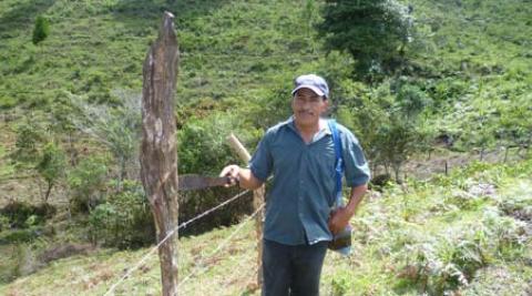 Agustin standing beside fence