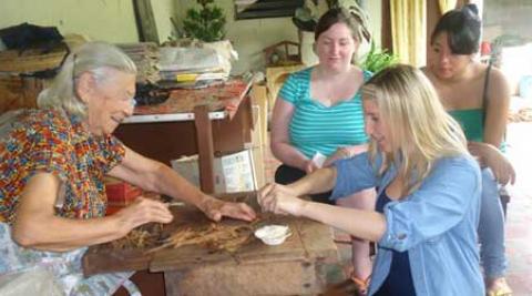 Lily learns to roll a cigar from a 91 year old pro.