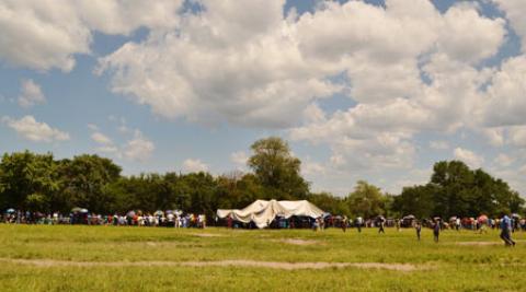  Setting the scene: People begin to arrive at Lubimbi primary school as the stak
