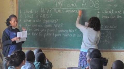 ICS Volunteers Yvonne and Charlee talking about HIV in a classroom in Zimbabwe