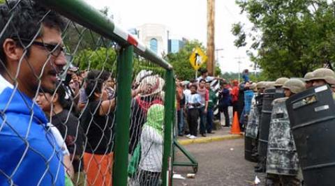 Protesters face riot control officers